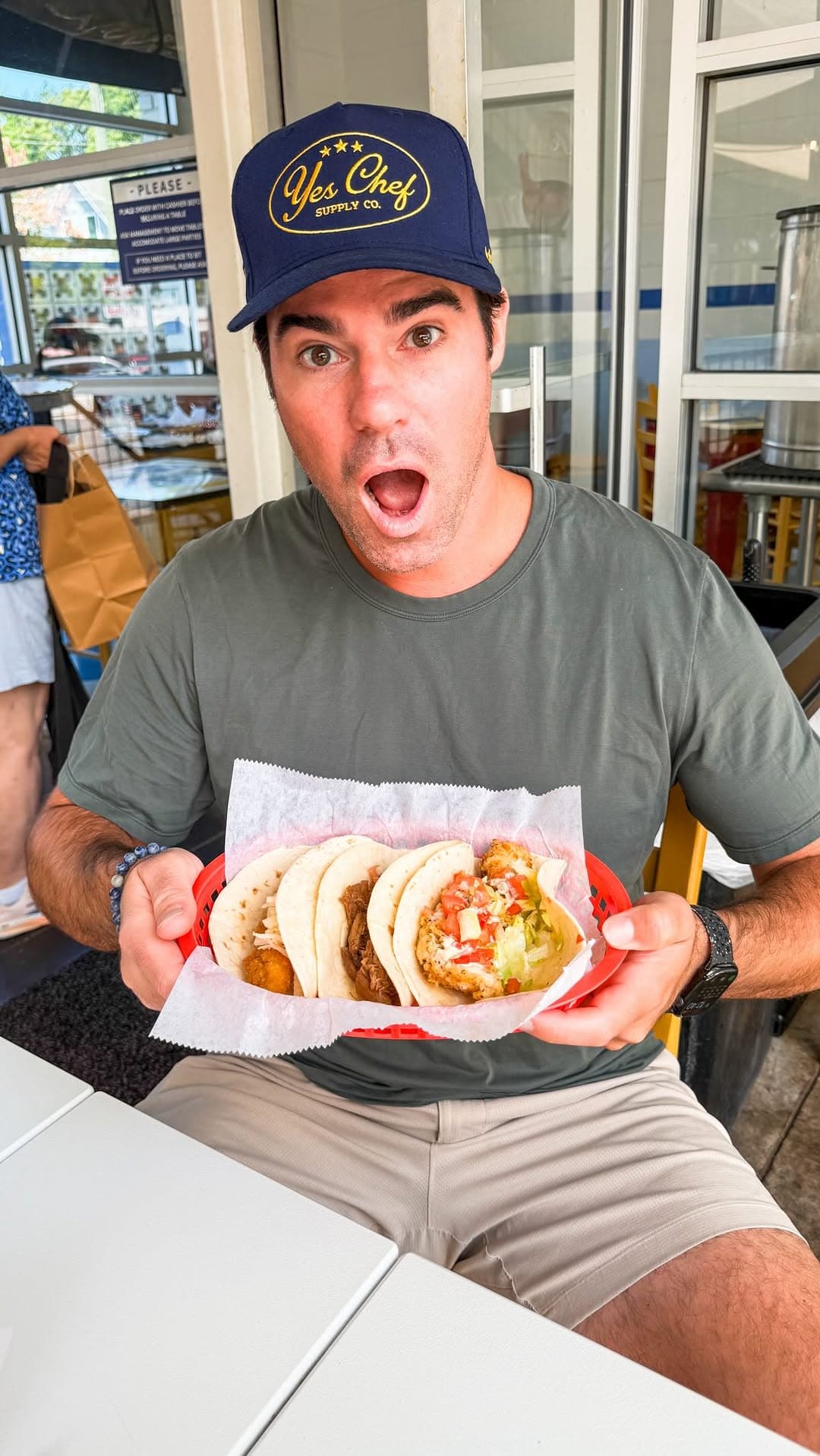 Holding a basket of tacos on the patio at Taqueria Del Sol in Decatur.